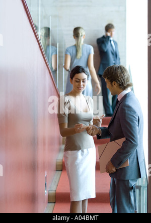 Businessman and woman exchanging business card Stock Photo