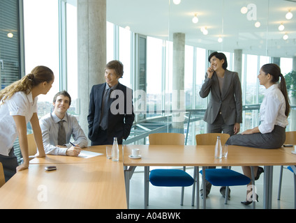 Business colleagues standing, discussing Stock Photo