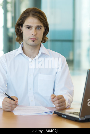 Young male executive working at desk Stock Photo