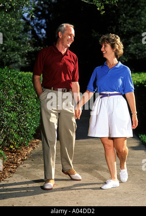 Healthy senior Couple Aged 60s Walking on Trail Outdoors Stock Photo