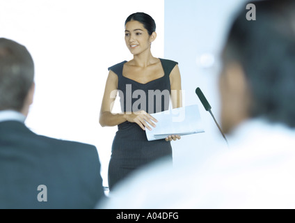 Executive woman standing next to microphone during seminar Stock Photo