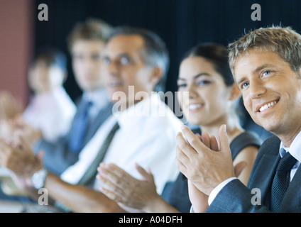 Executives sitting in seminar, clapping Stock Photo