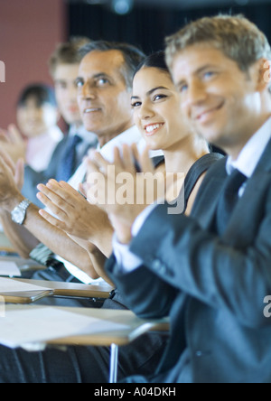 Executives sitting in seminar, clapping Stock Photo