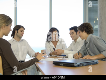 Business associates talking in conference room Stock Photo