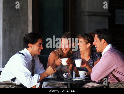 Two young couples age 20s having coffee in cafe Stock Photo