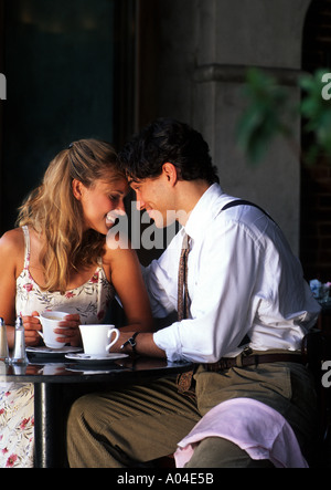 Young couple having affectionate talk in cafe Stock Photo