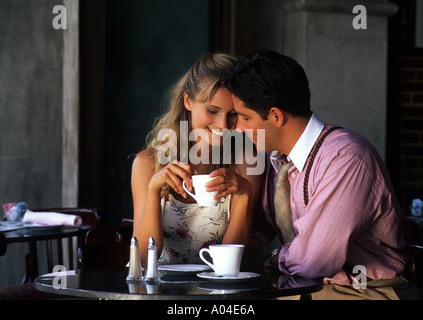 Young couple having affectionate talk in cafe Stock Photo