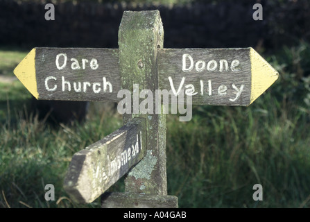 Lornd Doone area Malmsmead village road signpost & sign directions to Doone Valley footpath Exmoor National Park border of Devon & Somerset England UK Stock Photo