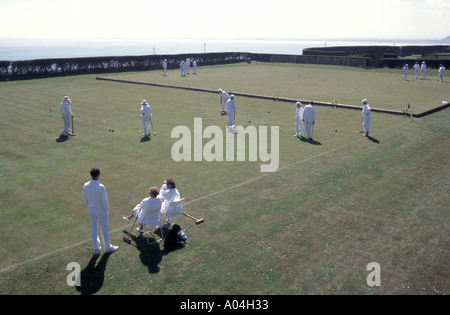 Ramsgate Croquet Club players taking part in games on several grass playing courts on the coast of this seaside resort in Kent England UK sea beyond Stock Photo