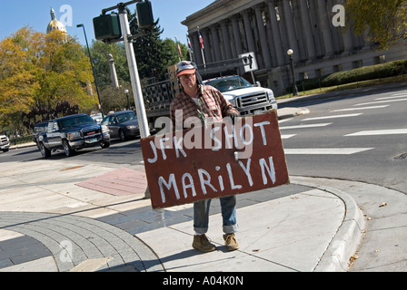 Conspiracy theorist displaying JFK sign on Denver street corner. Denver, Colorado, USA Stock Photo