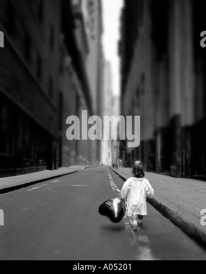 Little Girl Walking on the Street holding balloon  b&w image Stock Photo