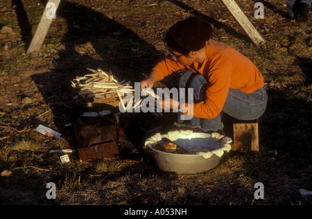 Violet Slwooko Lotscher cooking bannock bread on outdoor stove. Saint Lawrence island; Bering sea, Alaska Stock Photo