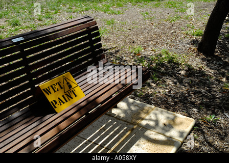 wet paint sign on park bench Stock Photo