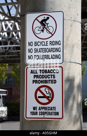 Signs prohibiting cycles skateboards rollerblades tobacco and smoking at bus station Bellingham Washington state USA Stock Photo