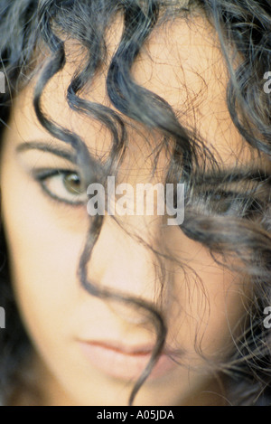 Close up portrait shot of an attractive curly haired brunette woman Stock Photo