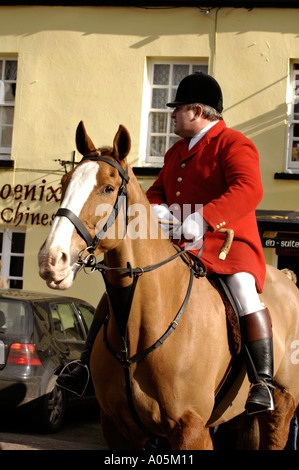 Huntsman in red coat riding horse at fox hunt meeting in UK Stock Photo