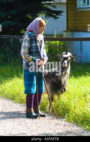 Old woman and billy goat Stock Photo