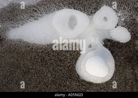 Natural phenomenon, Face formed of snow and airbubbles trapped underneath ice , Finland Stock Photo