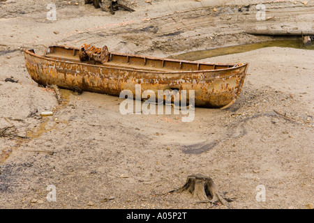 Abandoned boat, left derelict on bottom of Lokve lake in Croatia, Europe and stand visible on very low tide Stock Photo