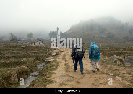 northwest Vietnam Sapa Black H Mong tribal area Lao Chai Village tourists trekking in the rain Stock Photo