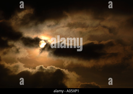 The Sun Appearing From Behind Clouds Stock Photo