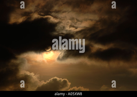 The Sun Appearing From Behind Clouds Stock Photo