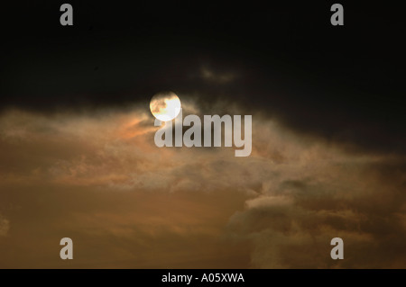 The Sun Appearing From Behind Clouds Stock Photo