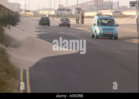 a road swamped with wind blown sand, following a severe storm, at Redcar, Teeside, England Stock Photo