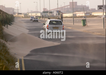 a road swamped with wind blown sand, following a severe storm, at Redcar, Teeside, England Stock Photo