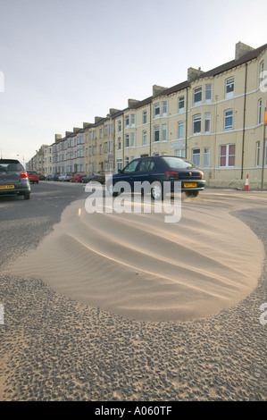 a road swamped with wind blown sand, following a severe storm, at Redcar, Teeside, England Stock Photo