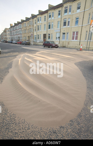 a road swamped with wind blown sand, following a severe storm, at Redcar, Teeside, England Stock Photo