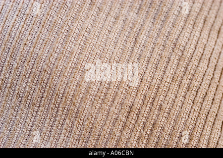 Close-up texture of a grey cord or corduroy fracture fabric showing ribbed pattern and soft textile details. Stock Photo