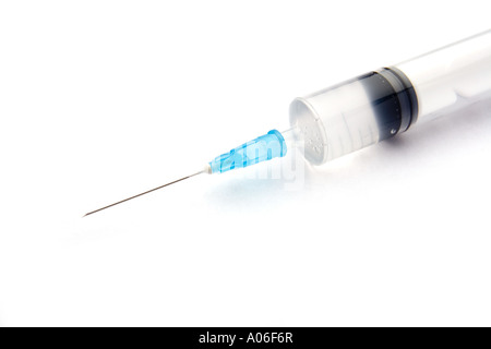 Needle and syringe on a white studio background. Stock Photo