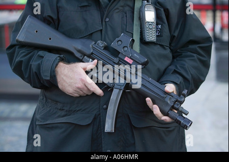 An armed metropolitan police officer standing guard outside the Houses ...
