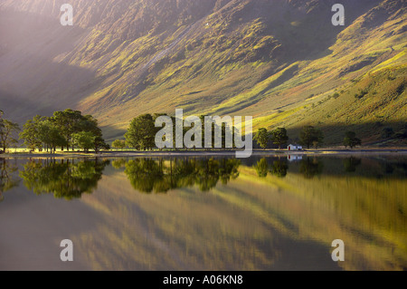 reflections on the shore of Buttermere at dawn Cumbria Lakes District Cumbria England UK