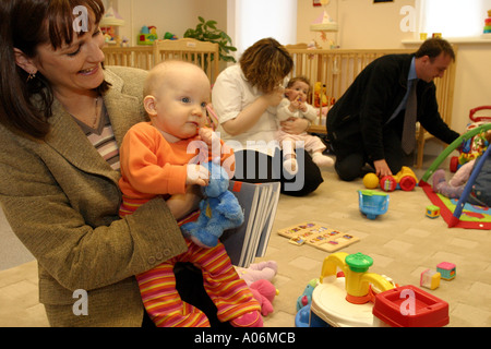 Parent dropping her baby off at the school's own nursery (she is a teacher at the school) Stock Photo