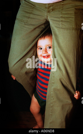 A baby looking through the legs of its mother COPYRIGHT GEORGE PHILIPAS MORAL RIGHTS ASSERTED Stock Photo