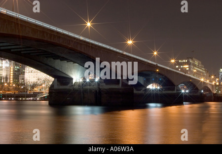 Waterloo Bridge at night from Thames foreshore. London, England Stock Photo