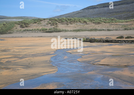 River running over sand Inter tidal zone Fanore beach County Clare Ireland Stock Photo