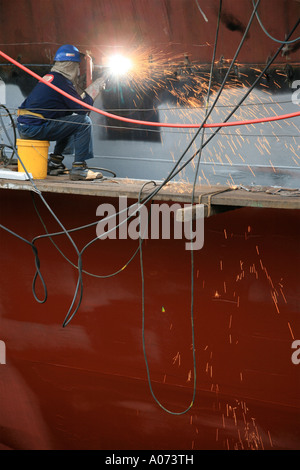 graphic detail shot of ship repair and ship painting and protective coating being applied at Hong Kong United Dockyard HUD Stock Photo