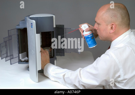 Man Cleaning Computer Printer With Compressed Air 2 Stock Photo