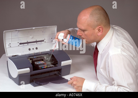 Man Cleaning Computer Printer With Compressed Air 3 Stock Photo