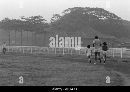 Father and children jogging at Mahalaxmi race course Bombay Mumbai India Stock Photo