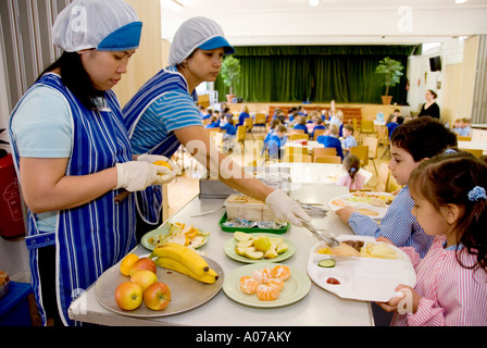 Healthy fruit being served to children in a  school canteen in Britain Stock Photo