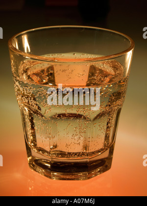 Glass of clean mineral sparkling water with ice on white background ...