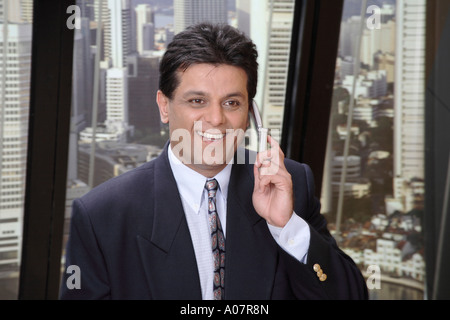 CEO talking on mobile phone in his cabin in business suit Stock Photo