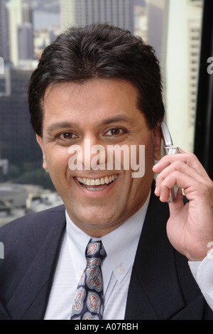 CEO laughing portrait on cellphone in his cabin in business suit Stock Photo