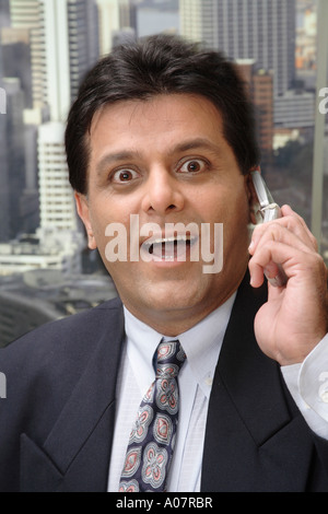 CEO portrait talking on cellphone in his cabin in business suit Stock Photo