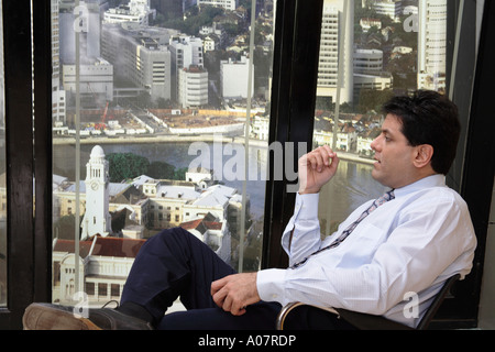 CEO thinking sitting in his cabin with city background Stock Photo