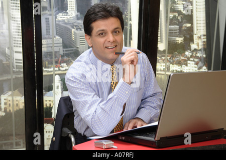 CEO working on laptop computer in his cabin with city background Stock Photo